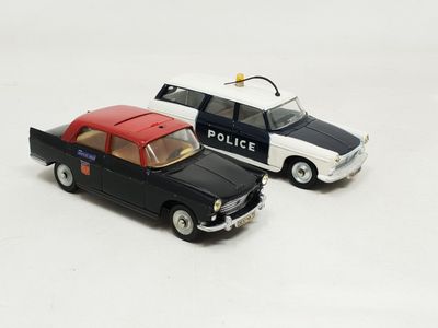 two toy cars sitting next to each other on a white surface