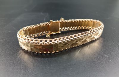 bracelet on a table with a black surface and a black background