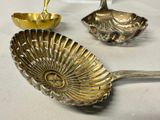 two spoons and a bowl sitting on a table