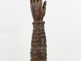 an image of a wooden sculpture of a hand on a pedestal