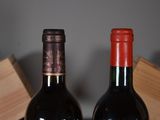 two bottles of wine sitting next to each other on a table