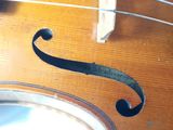a close up of a violin that is on a table