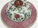 a plate with a lid that has a flower design on it
