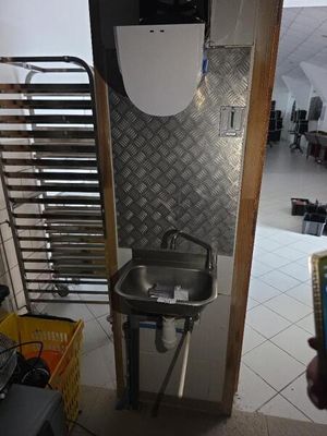 Quelqu'un prend une photo d'une salle de bains avec des toilettes et un lavabo.