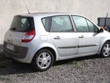 a small silver car parked in front of a building