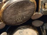 an image of a close up of a wrist watch on a black surface