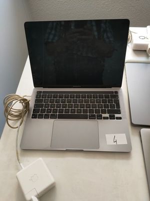 a laptop computer sitting on a desk next to a charger
