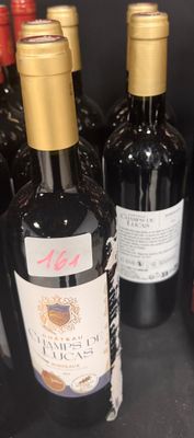 several bottles of wine are lined up on a shelf in a store