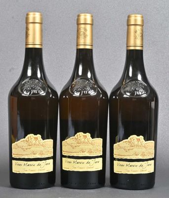 three bottles of wine sitting next to each other on a table