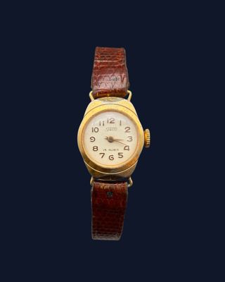 une image représentant une montre-bracelet en or sur fond noir