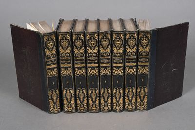 six books in a row on a table with a gray background