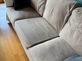 an image of a living room with a couch and a window