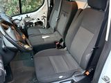 the interior of a white van with black seats and a steering wheel
