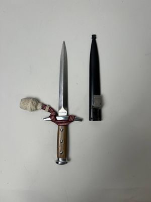 a knife and a bottle next to each other on a table