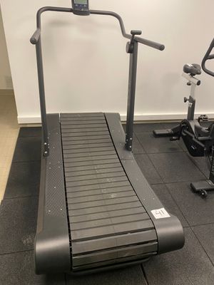 a treadmill and a stationary bike in a gym