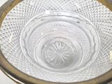 a glass bowl with a gold rim sitting on a table