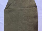a close up of a piece of brown paper on a white surface