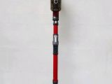 an image of a red and black cordless vacuum cleaner