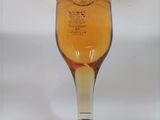 une photo d'une bouteille d'alcool posée sur une table blanche