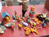 doll figurines on a red table with a red table cloth