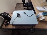 a desk with a laptop and headphones on top of it