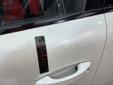 a close up of a car door handle with a sticker on it