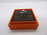 a close up of a ring in a box on a table