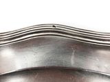 a close up of a metal object on a white surface