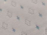 close up of a white fabric with blue stars on it
