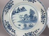 two plates with blue and white designs on them
