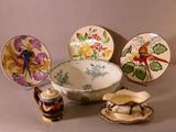 a lot of plates and bowls that are on the table