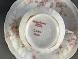 a cup and saucer sitting on a plate on a table