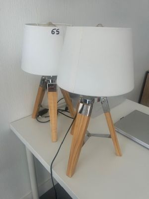 two lamps sitting on a table with a laptop on it