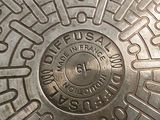 a close up of a manhole cover with a circular design