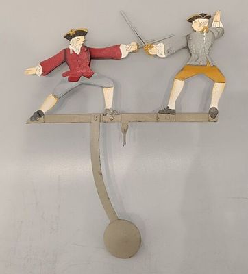 two figurines of two men playing a game of sword fighting