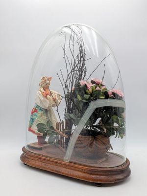 a glass dome with a figurine inside of it