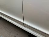 a white car with a black stripe on the side of it