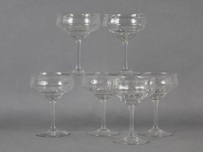 six clear wine glasses sitting on top of each other on a table