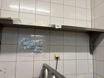 une photo d'une cuisine avec un évier et un micro-ondes