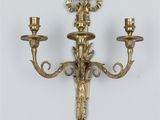 a pair of brass candlesticks on a white background