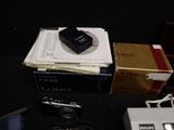 a box of electronic equipment sitting on a table next to a laptop