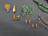 a lot of jewelry that is laying out on the table