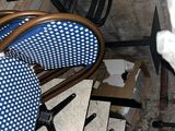 a blue and white polka dot chair next to a stack of chairs