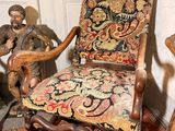 a chair with a floral upholstered seat in a corner of a room