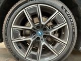 the wheel of a bmw car is shown with a tire sticker