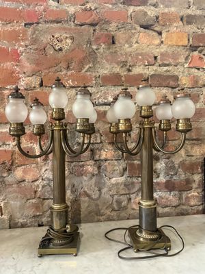 trois lampes de table anciennes en laiton et en verre posées sur une table en marbre