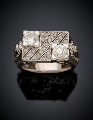 a close up of a diamond ring on a black surface