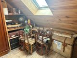 a room with a lot of luggage and a table and chairs