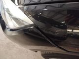 a close up of a car ' s headlight with a reflection on it