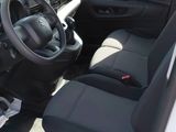 the interior of a white van with black seats and a steering wheel